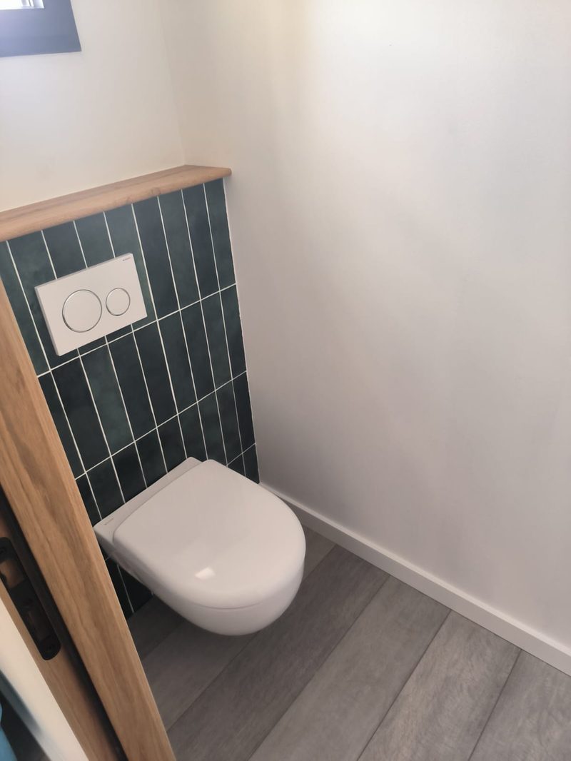 WC suspendu carrelage vert finitions soignées